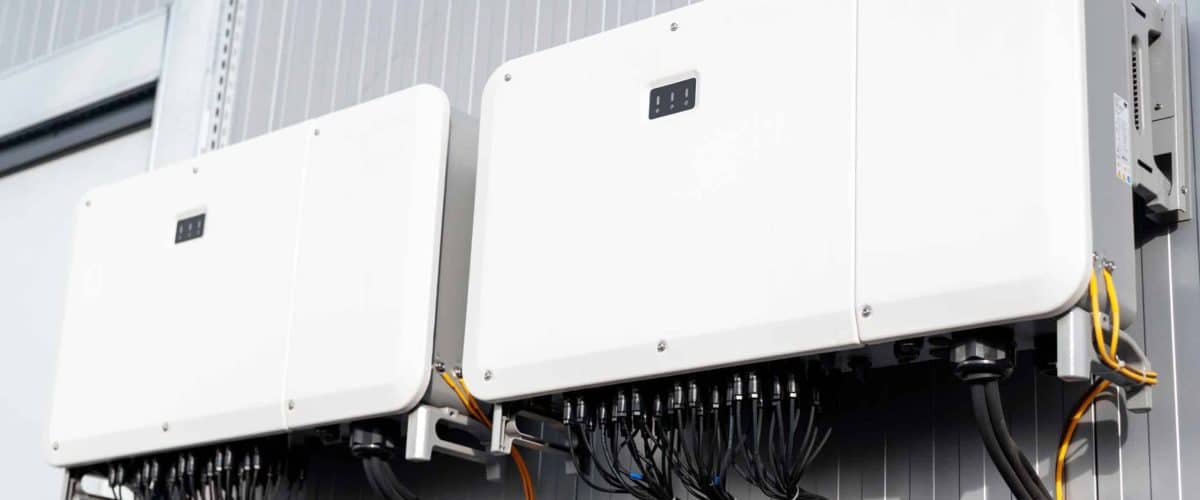 Close view of supporting systems for solar panels located on a manufacturing building , lots of connected wires. Ecology thematics